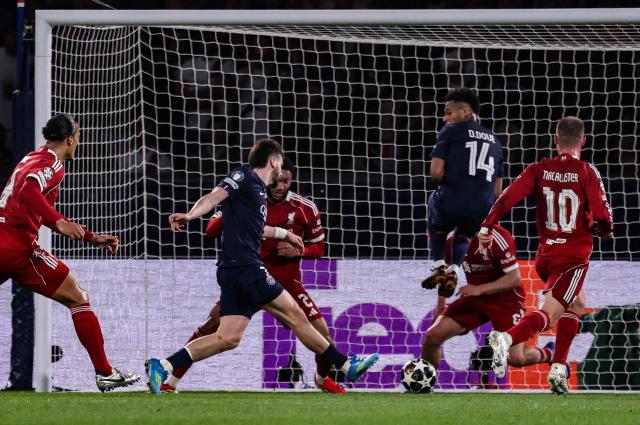 Paris Saint-Germain's Georgian forward #07 Khvicha Kvaratskhelia (C) shoots and scores his team's second goal  during the UEFA Champions League quarter-final first leg football match between Paris Saint-Germain (PSG) and Liverpool FC at the Parc des Princes stadium in Paris on April 8, 2026. (Photo by FRANCK FIFE / AFP)