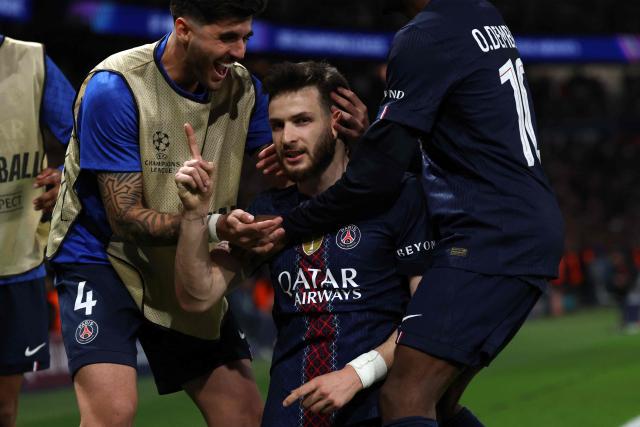 Paris Saint-Germain's Georgian forward #07 Khvicha Kvaratskhelia celebrates with teammates after scoring his team's second goal during the UEFA Champions League quarter-final first leg football match between Paris Saint-Germain (PSG) and Liverpool FC at the Parc des Princes stadium in Paris on April 8, 2026. (Photo by Anne-Christine POUJOULAT / AFP)