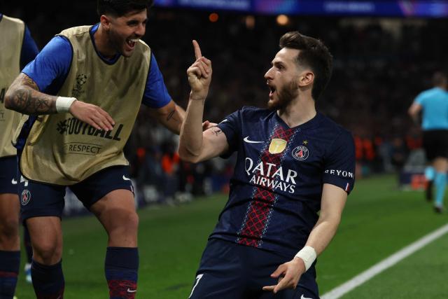 Paris Saint-Germain's Georgian forward #07 Khvicha Kvaratskhelia celebrates with teammates after scoring his team's second goal during the UEFA Champions League quarter-final first leg football match between Paris Saint-Germain (PSG) and Liverpool FC at the Parc des Princes stadium in Paris on April 8, 2026. (Photo by Anne-Christine POUJOULAT / AFP)