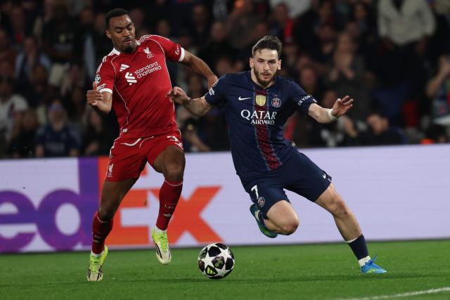 Paris Saint-Germain's Georgian forward #07 Khvicha Kvaratskhelia (R) fights for the ball with Liverpool's Dutch midfielder #38 Ryan Gravenberch on his way to scoring his team's second goal during the UEFA Champions League quarter-final first leg football match between Paris Saint-Germain (PSG) and Liverpool FC at the Parc des Princes stadium in Paris on April 8, 2026. (Photo by Anne-Christine POUJOULAT / AFP)