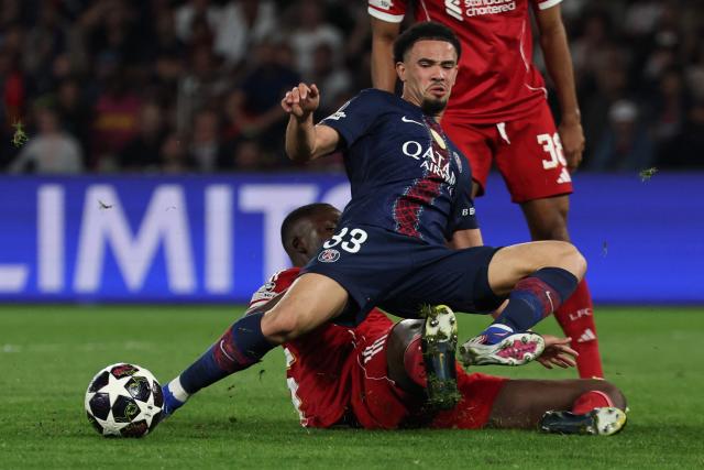Paris Saint-Germain's French midfielder #33 Warren Zaire-Emery is tackled during the UEFA Champions League quarter-final first leg football match between Paris Saint-Germain (PSG) and Liverpool FC at the Parc des Princes stadium in Paris on April 8, 2026. (Photo by Anne-Christine POUJOULAT / AFP)