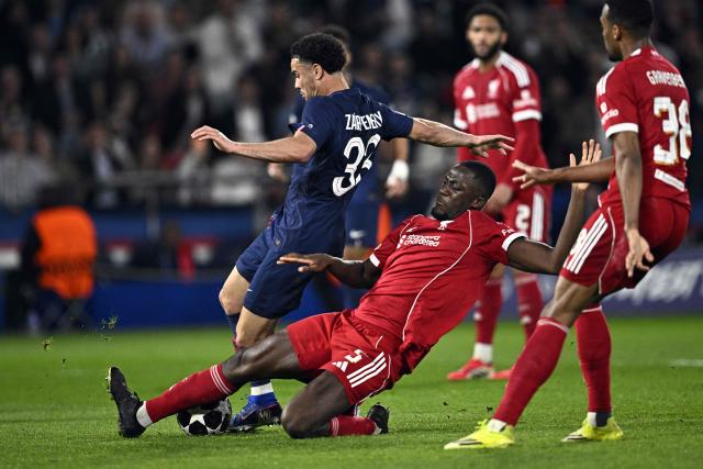 Paris Saint-Germain's French midfielder #33 Warren Zaire-Emery is tackled by Liverpool's French defender #05 Ibrahima Konate during the UEFA Champions League quarter-final first leg football match between Paris Saint-Germain (PSG) and Liverpool FC at the Parc des Princes stadium in Paris on April 8, 2026. (Photo by JULIEN DE ROSA / AFP)