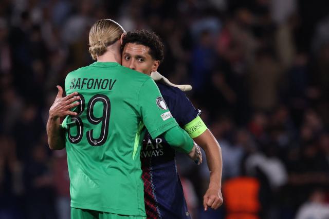 Paris Saint-Germain's Brazilian defender #05 Marquinhos (R) celebrates with Paris Saint-Germain's Russian goalkeeper #39 Matvey Safonov after winning the UEFA Champions League quarter-final first leg football match between Paris Saint-Germain (PSG) and Liverpool FC at the Parc des Princes stadium in Paris on April 8, 2026. (Photo by FRANCK FIFE / AFP)