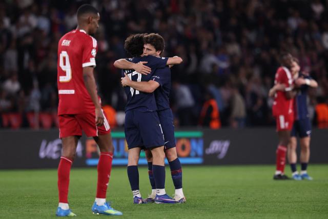 Paris Saint-Germain's Portuguese midfielder #87 Joao Neves (R) celebrates with Paris Saint-Germain's Portuguese midfielder #17 Vitinha (C) after winning  the UEFA Champions League quarter-final first leg football match between Paris Saint-Germain (PSG) and Liverpool FC at the Parc des Princes stadium in Paris on April 8, 2026. (Photo by FRANCK FIFE / AFP)