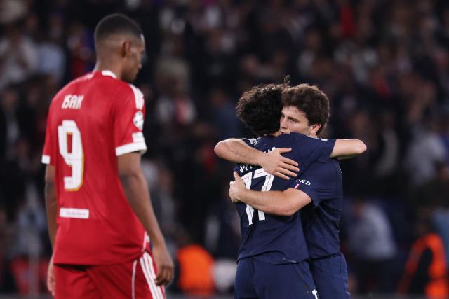Paris Saint-Germain's Portuguese midfielder #87 Joao Neves (R) celebrates with Paris Saint-Germain's Portuguese midfielder #17 Vitinha (C) after winning  the UEFA Champions League quarter-final first leg football match between Paris Saint-Germain (PSG) and Liverpool FC at the Parc des Princes stadium in Paris on April 8, 2026. (Photo by FRANCK FIFE / AFP)