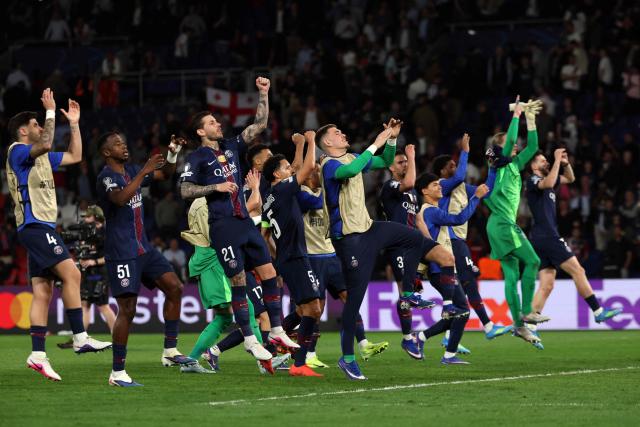 Paris' players celebrate their victory at the end of the UEFA Champions League quarter-final first leg football match between Paris Saint-Germain (PSG) and Liverpool FC at the Parc des Princes stadium in Paris on April 8, 2026. (Photo by Anne-Christine POUJOULAT / AFP)
