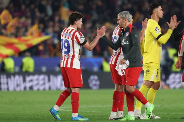 Atletico Madrid's French forward #07 Antoine Griezmann (C) and Atletico Madrid's Argentine forward #19 Julian Alvarez slap hands after the UEFA Champions League quarter final first leg football match between FC Barcelona and Club Atletico de Madrid at Camp Nou Stadium in Barcelona on April 8, 2026. (Photo by Lluis GENE / AFP)
