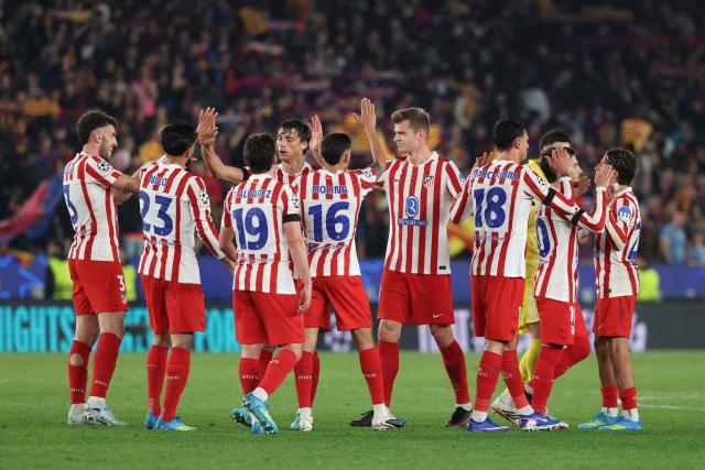 Atletico Madrid players react at the end of the UEFA Champions League quarter final first leg football match between FC Barcelona and Club Atletico de Madrid at Camp Nou Stadium in Barcelona on April 8, 2026. (Photo by Lluis GENE / AFP)