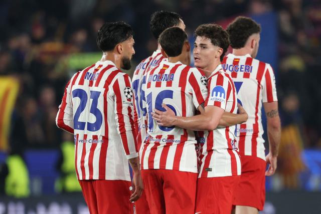 Atletico Madrid players react at the end of the UEFA Champions League quarter final first leg football match between FC Barcelona and Club Atletico de Madrid at Camp Nou Stadium in Barcelona on April 8, 2026. (Photo by Lluis GENE / AFP)