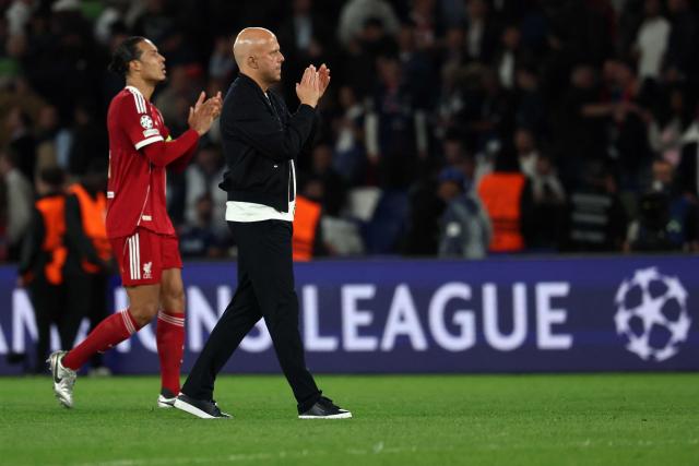 Liverpool's Dutch coach Arne Slot (2ndL) and Liverpool's Dutch defender #04 Virgil van Dijk react at the end of the UEFA Champions League quarter-final first leg football match between Paris Saint-Germain (PSG) and Liverpool FC at the Parc des Princes stadium in Paris on April 8, 2026. (Photo by Anne-Christine POUJOULAT / AFP)
