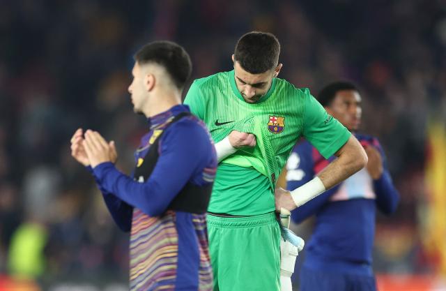 Barcelona's Spanish goalkeeper #13 Joan Garcia looks dejected at the end of the UEFA Champions League quarter final first leg football match between FC Barcelona and Club Atletico de Madrid at Camp Nou Stadium in Barcelona on April 8, 2026. Atletico Madrid won 0-2. (Photo by Josep LAGO / AFP)