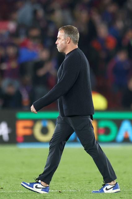 Barcelona's German coach Hans-Dieter Flick leaves at the end of the UEFA Champions League quarter final first leg football match between FC Barcelona and Club Atletico de Madrid at Camp Nou Stadium in Barcelona on April 8, 2026. Atletico Madrid won 0-2. (Photo by Josep LAGO / AFP)