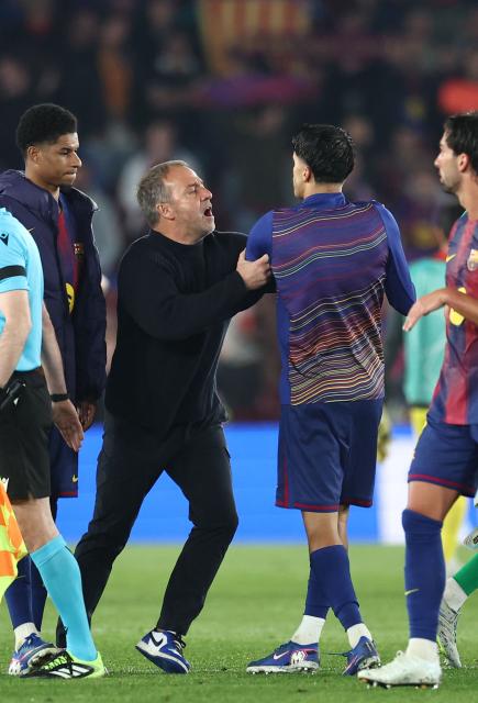 Barcelona's German coach Hans-Dieter Flick prevents Barcelona's Portuguese defender #02 Joao Cancelo from discussing with referee at the end of the UEFA Champions League quarter final first leg football match between FC Barcelona and Club Atletico de Madrid at Camp Nou Stadium in Barcelona on April 8, 2026. Atletico Madrid won 0-2. (Photo by Josep LAGO / AFP)