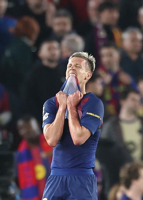 Barcelona's Spanish midfielder #20 Daniel Olmo reacts at the end of the UEFA Champions League quarter final first leg football match between FC Barcelona and Club Atletico de Madrid at Camp Nou Stadium in Barcelona on April 8, 2026. Atletico Madrid won 0-2. (Photo by Josep LAGO / AFP)