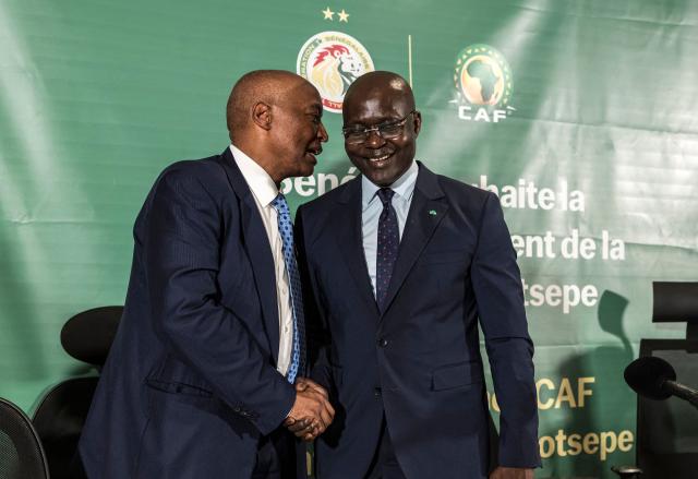President of Confederation of African Football (CAF) Patrice Motsepe (L) speaks with the president of the Senegalese Football Federation (SFS) Abdoulaye Fall (R) at the end of a press conference at the Pullman Hotel in Dakar on April 8, 2026. The president of the Confederation of African Football (CAF) was in Dakar on April 8, 2026, nearly a month after the body's shock decision to strip Senegal of its AFCON title and award it to Morocco. (Photo by PATRICK MEINHARDT / AFP)