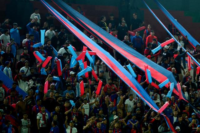 San Lorenzo fans cheer before the Copa Sudamericana group stage football match between Paraguay's Deportivo Recoleta and Argentina's San Lorenzo at the Defensores del Chaco stadium in Asuncion on April 8, 2026. (Photo by Daniel Duarte / AFP)