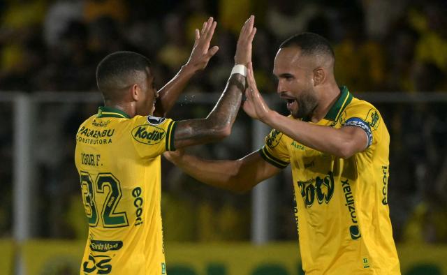 Mirassol's defender #34 Joao Victor (R) celebrates with teammate defender #32 Igor Formiga after scoring his team's first goal during the Copa Libertadores group stage football match between Brazil's Mirassol and Argentina's Lanus at the Jose Maria de Campos Maia stadium in Mirassol, state of Sao Paulo, Brazil, on April 8, 2026. (Photo by NELSON ALMEIDA / AFP)