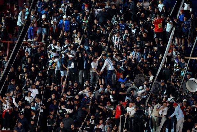 Fans of Deportivo Riestra cheer for their team during the Copa Sudamericana group stage football match between Argentina's Deportivo Riestra and Chile's Palestino at the Pedro Bidegain stadium in Buenos Aires on April 8, 2026. (Photo by ALEJANDRO PAGNI / AFP)