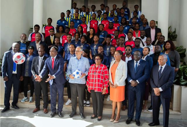 Haitian Prime Minister Alix Didier Fils-Aime (C-front row), Haitian Football Federation (FHF) President Marie Monique Andre (4th-R), Sports Minister Pythagore Dumas (3rd-L) pose for a photo with other officials and players during a presentation to the Haitian Football Federation of World Cup qualification bonuses and team preparations at the Villa d’Accueil in Port-au-Prince, on April 8, 2026. (Photo by Clarens SIFFROY / AFP)