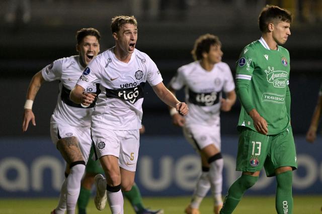 Olimpia's Argentine midfielder #05 Juan Alfaro celebrates scoring his team's second goal during the Copa Sudamericana group stage football match between Chile's Audax Italiano and Paraguay's Olimpia at the Bicentenario de la Florida stadium in Santiago on April 8, 2026. (Photo by Rodrigo ARANGUA / AFP)