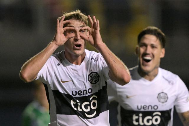 Olimpia's Argentine midfielder #05 Juan Alfaro celebrates scoring his team's second goal during the Copa Sudamericana group stage football match between Chile's Audax Italiano and Paraguay's Olimpia at the Bicentenario de la Florida stadium in Santiago on April 8, 2026. (Photo by Rodrigo ARANGUA / AFP)