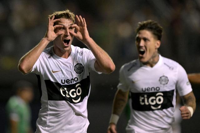 Olimpia's Argentine midfielder #05 Juan Alfaro celebrates scoring his team's second goal during the Copa Sudamericana group stage football match between Chile's Audax Italiano and Paraguay's Olimpia at the Bicentenario de la Florida stadium in Santiago on April 8, 2026. (Photo by Rodrigo ARANGUA / AFP)