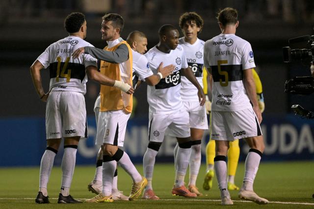 Players of Olimpia celebrate after winning the Copa Sudamericana group stage football match between Chile's Audax Italiano and Paraguay's Olimpia at the Bicentenario de la Florida stadium in Santiago on April 8, 2026. (Photo by Rodrigo ARANGUA / AFP)