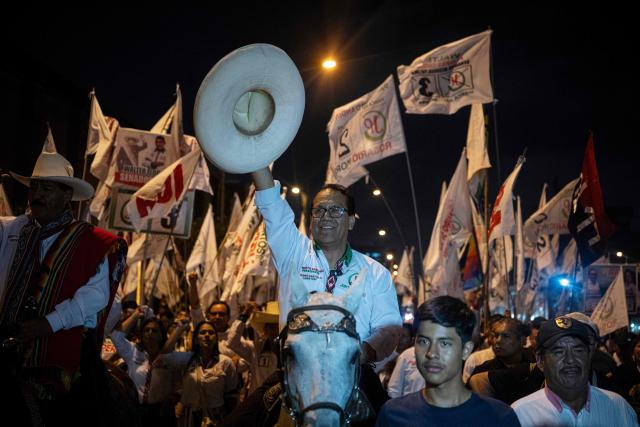 Peru's presidential candidate Roberto Sanchez, for the Juntos por el Peru party, gestures upon arrival at his closing campaign rally at 2 de Mayo Square in Lima on April 8, 2026. Peru will hold presidential elections on April 12. (Photo by Ernesto BENAVIDES / AFP)