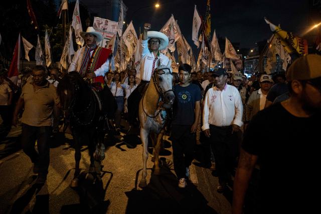 Peru's presidential candidate Roberto Sanchez, for the Juntos por el Peru party, gestures upon arrival at his closing campaign rally at 2 de Mayo Square in Lima on April 8, 2026. Peru will hold presidential elections on April 12. (Photo by Ernesto BENAVIDES / AFP)