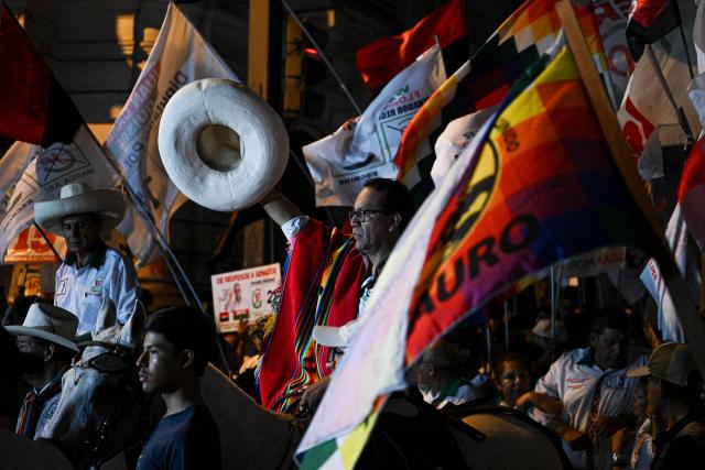 Peru's presidential candidate Roberto Sanchez, for the Juntos por el Peru party, gestures upon arrival at his closing campaign rally at 2 de Mayo Square in Lima on April 8, 2026. Peru will hold presidential elections on April 12. (Photo by Ernesto BENAVIDES / AFP)