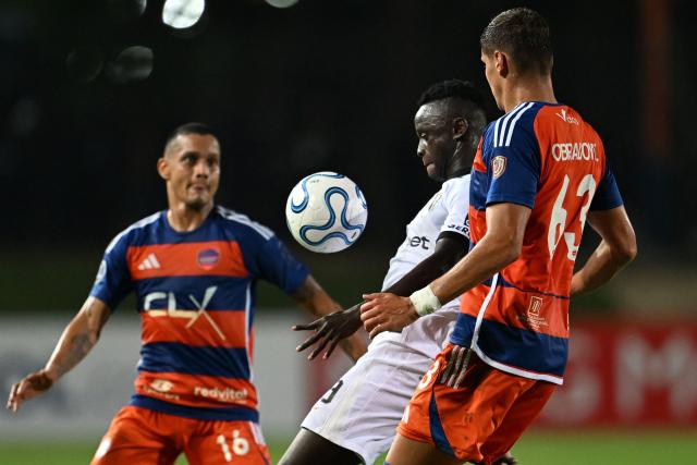 Puerto Cabello's defender #16 Roberto Rosales, Atletico Mineiro's Guinean midfielder #39 Mamady Cisse and Puerto Cabello's Serbian defender #63 Stefan Obradovic fight for the ball during the Copa Sudamericana group stage football match between Venezuela's Academia Puerto Cabello and Brazil's Atletico Mineiro at the Misael Delgado stadium in Valencia, state of Carabobo, Venezuela, on April 8, 2026. (Photo by Juan BARRETO / AFP)