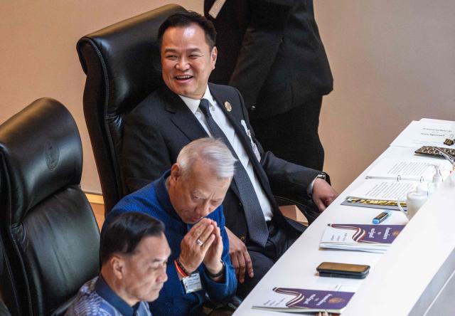Thailand's Prime Minister Anutin Charnvirakul (top) sits before delivering the cabinet policy speech at the parliament chamber in Bangkok on April 9, 2026. (Photo by chanakarn LAOSARAKHAM / AFP)