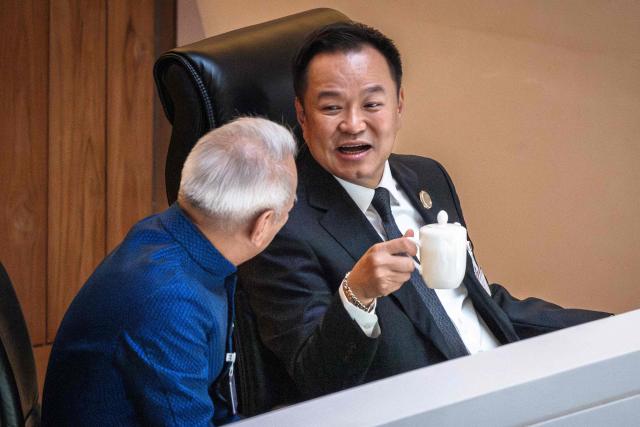 Thailand's Prime Minister Anutin Charnvirakul (R) sits before delivering the cabinet policy speech at the parliament chamber in Bangkok on April 9, 2026. (Photo by chanakarn LAOSARAKHAM / AFP)