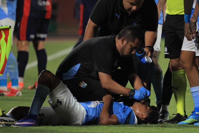Sporting Cristal's forward #23 Maxloren Castro receives medical attention during the Copa Libertadores group stage football match between Peru's Sporting Cristal and Paraguay's Cerro Porteno at the Nacional stadium in Lima, on April 8, 2026. (Photo by Connie FRANCE / AFP)