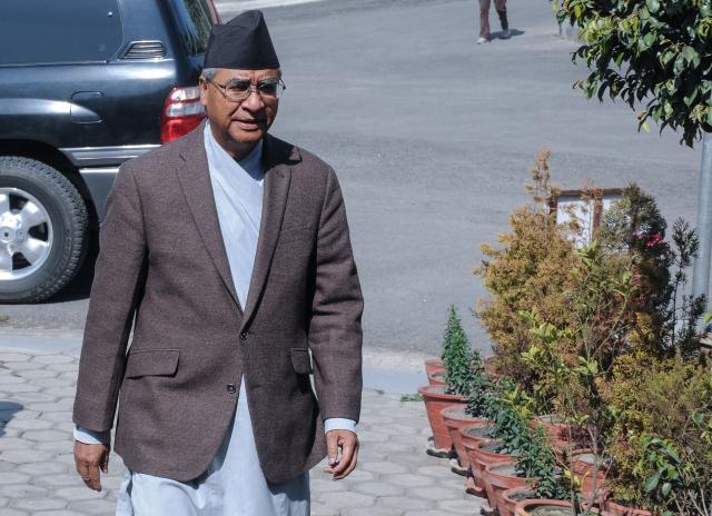 (FILES) Nepali Prime Minister Sher Bahadur Deuba arrives for his address to the nation before submitting his resignation to the president at his official residence in Baluwatar in Kathmandu on February 15, 2018. Nepal has issued an arrest warrant for former prime minister Sher Bahadur Deuba for alleged corruption, officials said on April 9, 2026 making him the latest high-profile figure targeted under the new government. (Photo by Bikash KARKI / AFP)