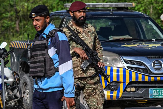Security personnel stand guard at a checkpoint in the Red Zone area of Islamabad on April 9, 2026. Pakistan has been preparing for high-stakes talks involving US and Iranian representatives over the war in the Middle East, with the White House saying Vice President JD Vance will be leading a team to the negotiations in Islamabad "this weekend". (Photo by Aamir QURESHI / AFP)