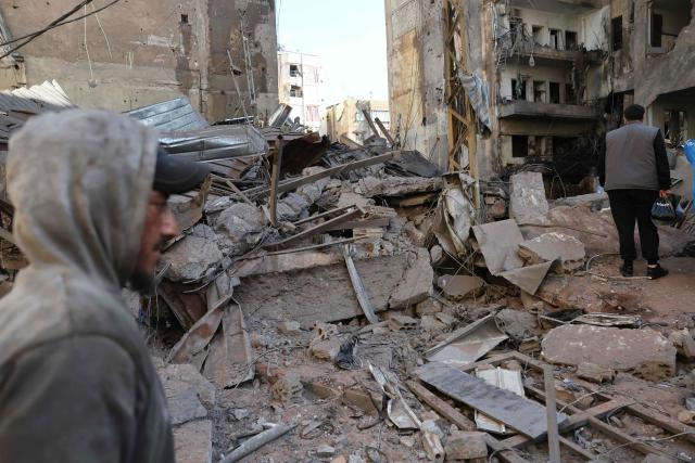 This picture taken on April 9, 2026, shows people walking at the site of the previos day's Israeli airstrikes that targeted the Shiah area in the southern suburbs of Beirut. The Israeli military said it struck a Hezbollah commander in Beirut on April 8, after Lebanese state media reported that Israel had targeted a residential neighbourhood in the capital. (Photo by Anwar AMRO / AFP)