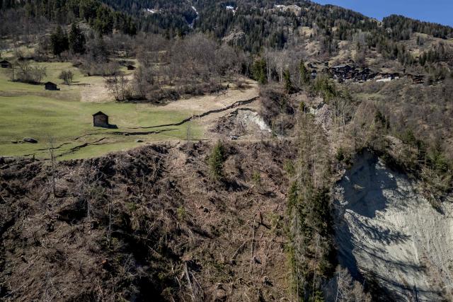 This aerial photograph shows the Fios fault line near Vissoie in the Val d’Anniviers, canton of Valais, southwestern Switzerland on April 8, 2026. The fracture is gradually widening, raising fears of a partial mountainside collapse that could block the river below and trigger flooding downstream. Authorities are monitoring the site and preparing safety and evacuation plans for the village of Chippis at the bottom of the valley. (Photo by Fabrice COFFRINI / AFP)
