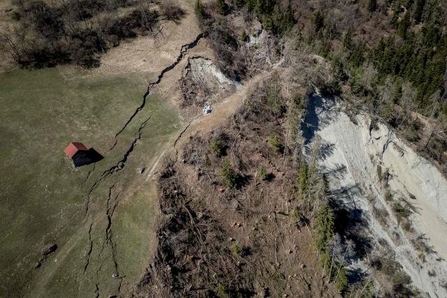 This aerial photograph shows the Fios fault line near Vissoie in the Val d’Anniviers, canton of Valais, southwestern Switzerland on April 8, 2026. The fracture is gradually widening, raising fears of a partial mountainside collapse that could block the river below and trigger flooding downstream. Authorities are monitoring the site and preparing safety and evacuation plans for the village of Chippis at the bottom of the valley. (Photo by Fabrice COFFRINI / AFP)