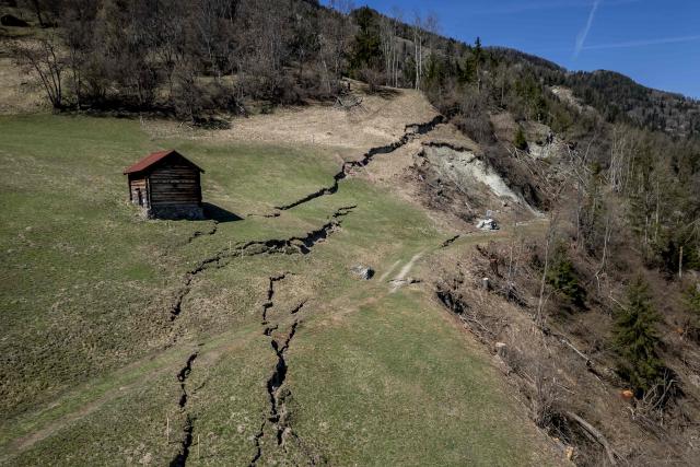 This aerial photograph shows the Fios fault line near Vissoie in the Val d’Anniviers, canton of Valais, southwestern Switzerland on April 8, 2026. The fracture is gradually widening, raising fears of a partial mountainside collapse that could block the river below and trigger flooding downstream. Authorities are monitoring the site and preparing safety and evacuation plans for the village of Chippis at the bottom of the valley. (Photo by Fabrice COFFRINI / AFP)
