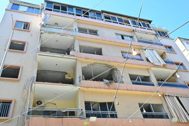 A first responder inspects the site of the previous day's Israeli airstrike that targeted a building in Beirut's al-Manara neighbourhood on April 9, 2026. The Israeli military said it struck a Hezbollah commander in Beirut on April 8, after Lebanese state media reported that Israel had targeted a residential neighbourhood in the capital. (Photo by FADEL itani / AFP)