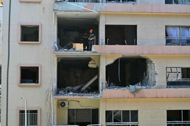 First responders inspect the site of the previous day's Israeli airstrike that targeted a building in Beirut's al-Manara neighbourhood on April 9, 2026. The Israeli military said it struck a Hezbollah commander in Beirut on April 8, after Lebanese state media reported that Israel had targeted a residential neighbourhood in the capital. (Photo by FADEL itani / AFP)