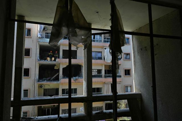 TOPSHOT - First responders inspect the site of the previous day's Israeli airstrike that targeted a building in Beirut's al-Manara neighbourhood on April 9, 2026. The Israeli military said it struck a Hezbollah commander in Beirut on April 8, after Lebanese state media reported that Israel had targeted a residential neighbourhood in the capital. (Photo by FADEL itani / AFP)