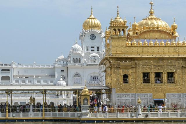 Sikh devotees vivist the Golden Temple to pay respects on the occasion of the birth anniversary of the fifth Sikh Guru Arjan Dev in Amritsar on April 9, 2026. (Photo by Narinder NANU / AFP)