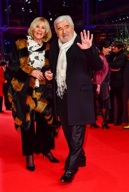 (FILES) German actor Mario Adorf and his wife Monique Adorf pose on the red carpet for the opening ceremony of the 68th Berlinale film festival with the premiere of "Isle of Dogs" on February 15, 2018 at the Berlinale Palace in Berlin. Actor Mario Adorf has died at the age of 95 on April 8, 2026, his longtime manager Michael Stark announced on April 9, 2026. He “passed away in his sleep in his apartment in Paris on Wednesday after a short illness,” he said. (Photo by Tobias SCHWARZ / AFP)