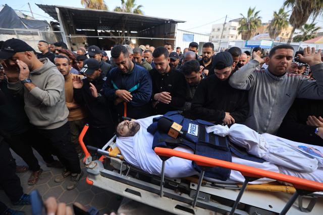 Mourners react as they attend the funeral of Al Jazeera journalist Mohammad Weshah, who was killed in an Israeli strike, at the Al-Aqsa Martyrs Hospital in Deir al-Balah in the central Gaza Strip, on April 9, 2026. Al Jazeera reported on April 8 that one of its journalists, Mohammed Washeha, was killed when an Israeli drone strike targeted his car in Gaza. “Al Jazeera correspondent Mohammed Washeha was martyred in the Gaza Strip after an Israeli drone targeted his car,” the channel said. (Photo by Eyad Baba / AFP)