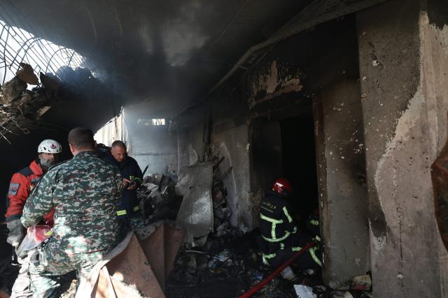 Lebanese first responders search under the rubble at the site of an Israeli airstrike that targeted a building the day before in Beirut's Corniche al-Mazraa neighbourhood on April 9, 2026. Rescuers searched for survivors under the rubble of destroyed buildings in Beirut as Lebanon observed a day of mourning after Israeli strikes across the country killed more than 200. (Photo by Ibrahim AMRO / AFP)