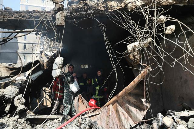 Lebanese first responders search under the rubble at the site of an Israeli airstrike that targeted a building the day before in Beirut's Corniche al-Mazraa neighbourhood on April 9, 2026. Rescuers searched for survivors under the rubble of destroyed buildings in Beirut as Lebanon observed a day of mourning after Israeli strikes across the country killed more than 200. (Photo by Ibrahim AMRO / AFP)