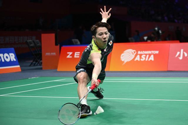 Koki Watanabe of Japan hits a return to Loh Kean Yew of Singapore during their men's single match at the Badminton Asia Championship in Ningbo, eastern China's Zhejiang province on April 9, 2026. (Photo by CN-STR / AFP) / China OUT
