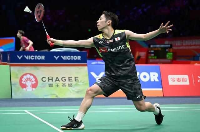 Koki Watanabe of Japan hits a return to Loh Kean Yew of Singapore during their men's single match at the Badminton Asia Championship in Ningbo, eastern China's Zhejiang province on April 9, 2026. (Photo by CN-STR / AFP) / China OUT